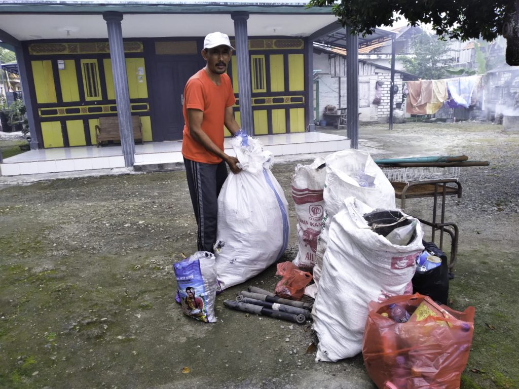 A local resident prepares bags of sorted waste for pick up to the nearest collection point.